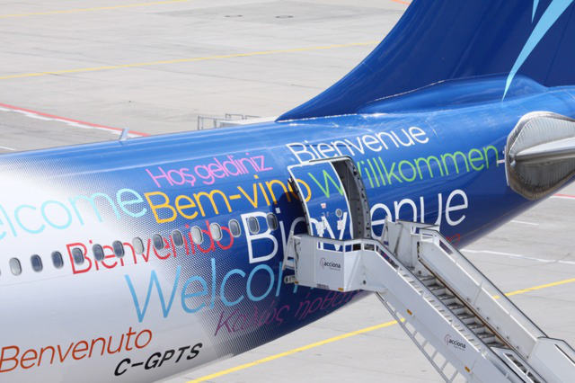 Airplane with welcome in different languages on it 