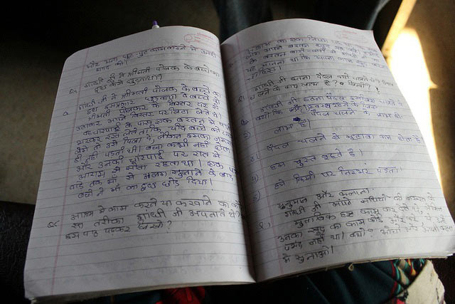 A notebook with Hindi writings in it.