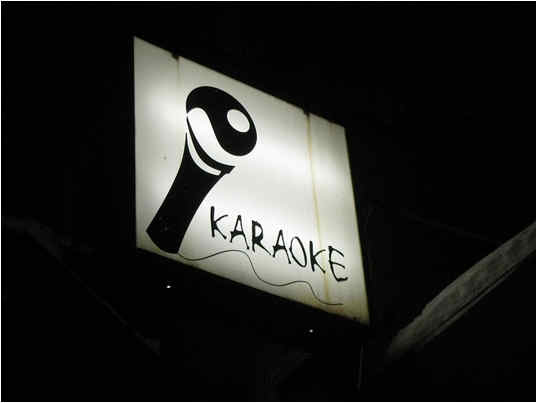 Karaoke sign outside a building.