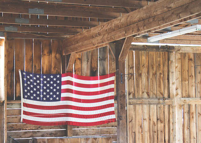 American Flag Hanging from Wooden Wall