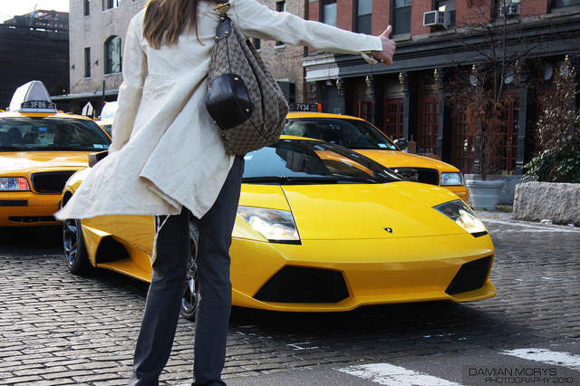 Woman Hailing Taxi Cab in City USA