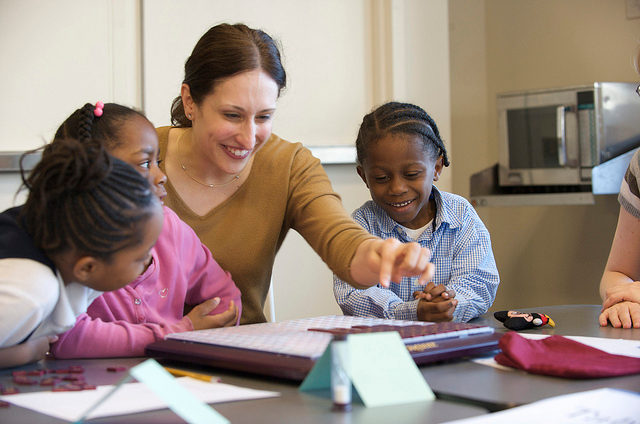 photo of a tutor with three students