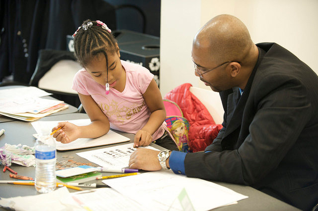 man male teacher tutoring a girl female student 