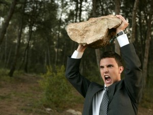Young Man In Suit Holding Rock