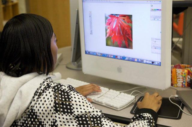 Woman using a computer learning how to use a computer