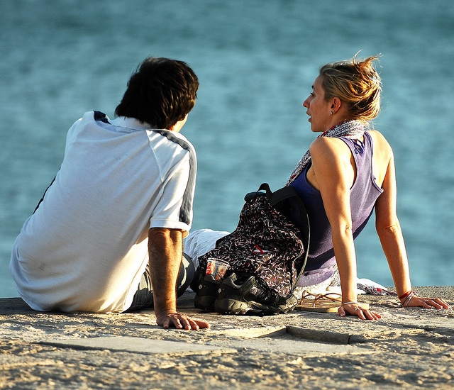 Two people having a conversation on the beach