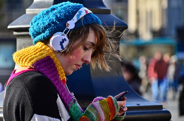 A girl listening from headphones