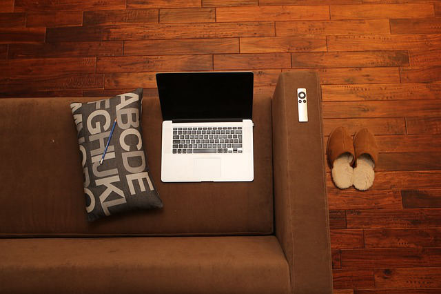 Living room sofa with laptop and slippers