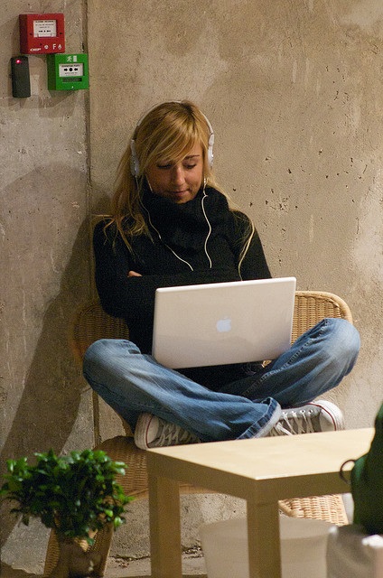 Woman listening on her laptop