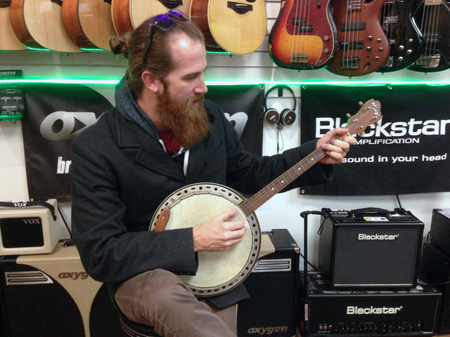 Man learning or playing Banjo 