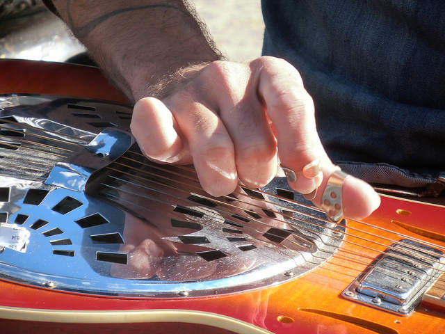 Man playing lap steel guitar horizontal slide guitarist 