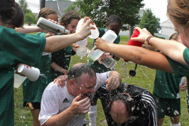 Girls playing with Coach after winning conference / division 